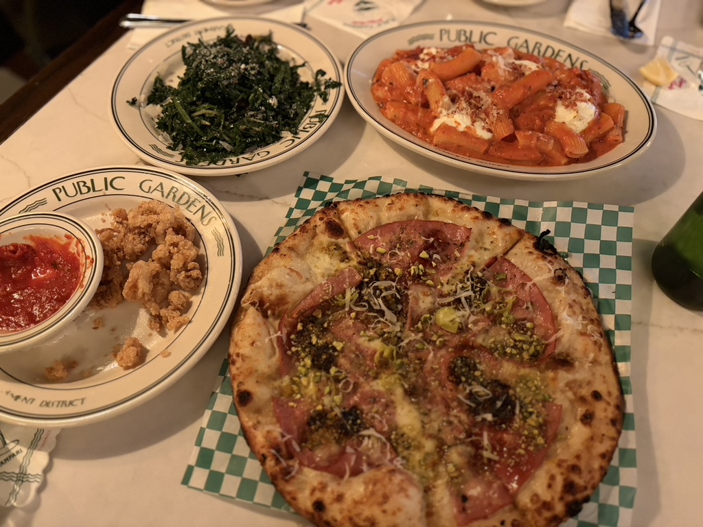 Dinner spread with pizza and shared dishes